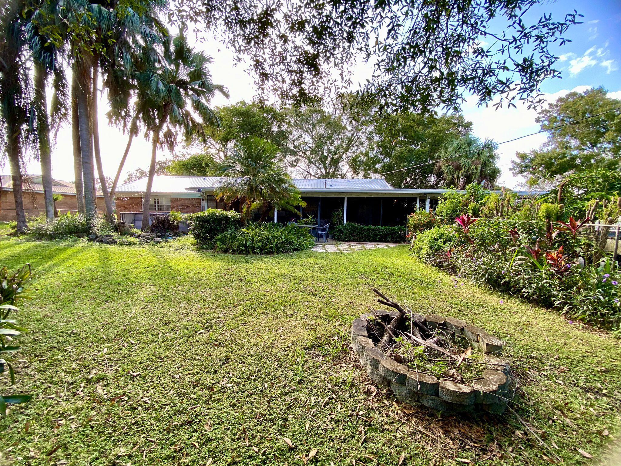 a view of a house with a yard and sitting area