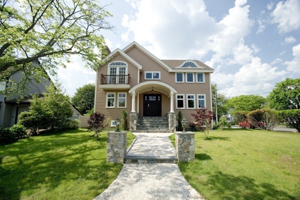 a front view of a house with a yard