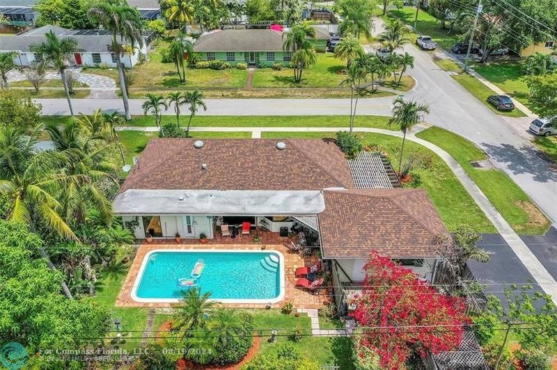 an aerial view of a house with garden space and street view