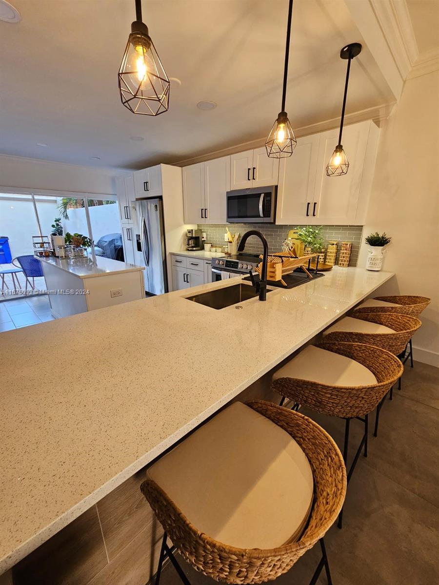 a room with table chairs and wooden floor