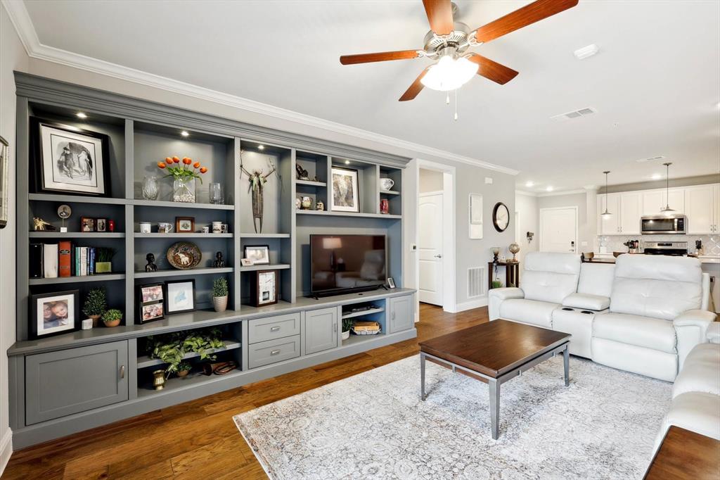 a living room with furniture a rug and a flat screen tv