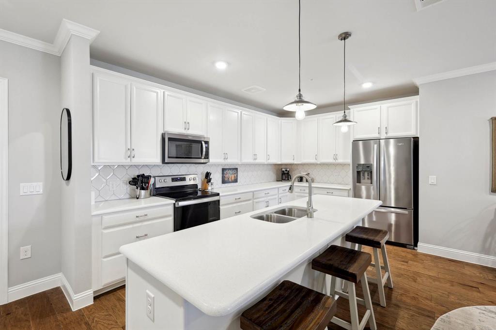 a kitchen with refrigerator cabinets and wooden floor