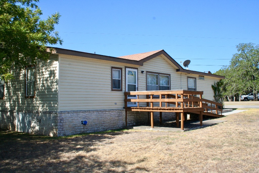 a view of a house with a wooden fence