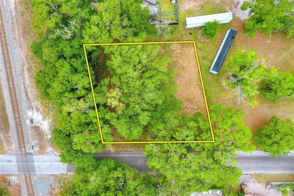 an aerial view of a houses with a yard