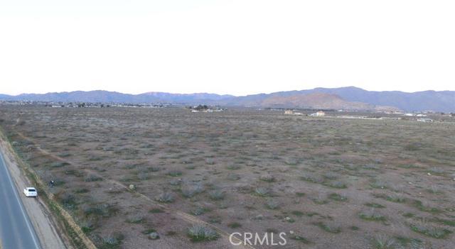 a view of a large mountain with a mountain in the background