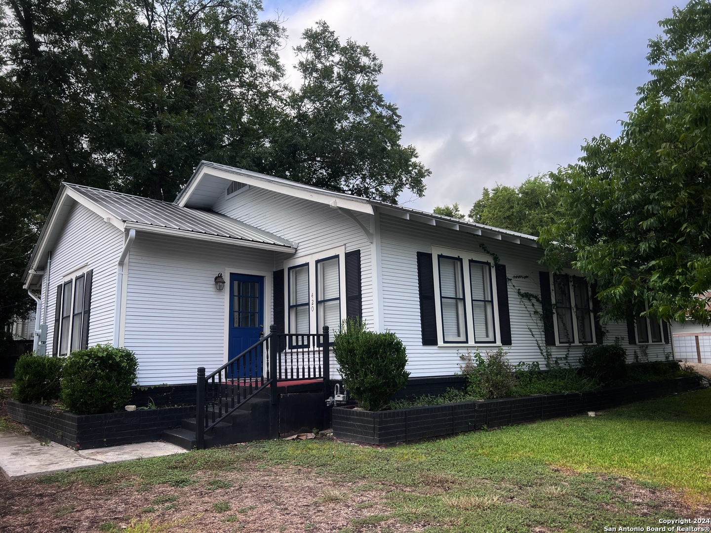 a front view of a house with garden