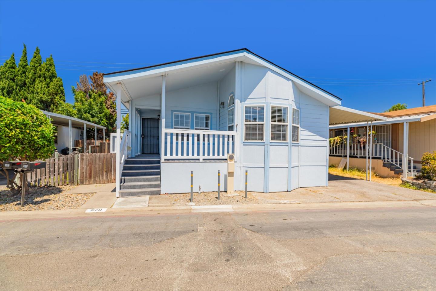 a view of a house with a yard and fence