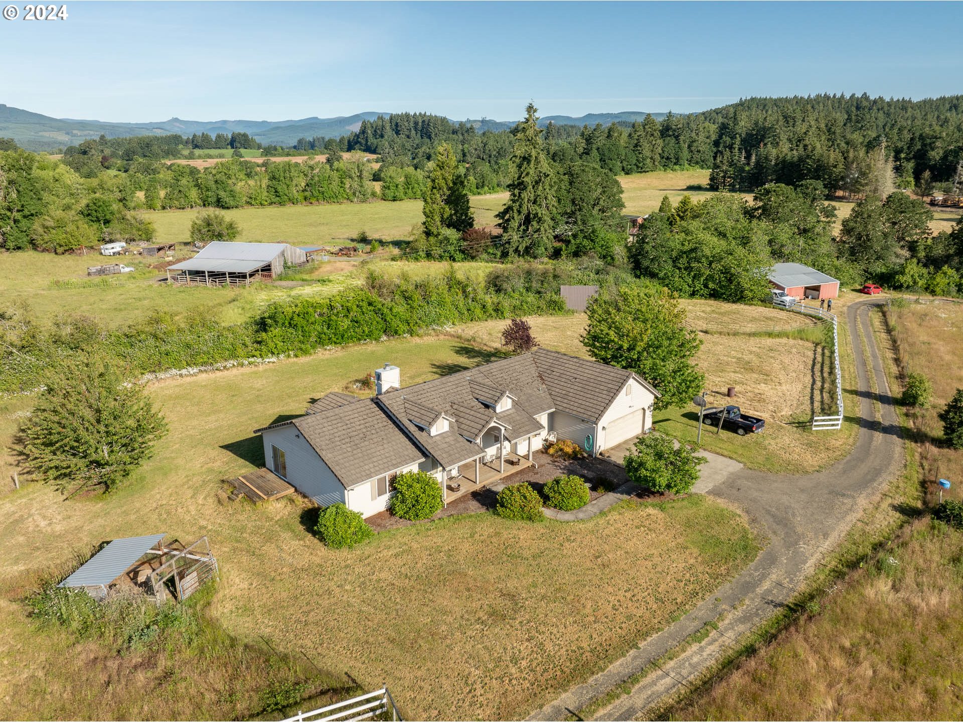 an aerial view of a house with garden space and mountain view