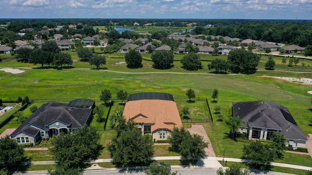 an aerial view of a house with outdoor space and pool