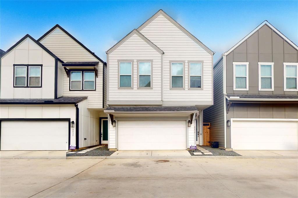 a front view of a house with a garage and a chair