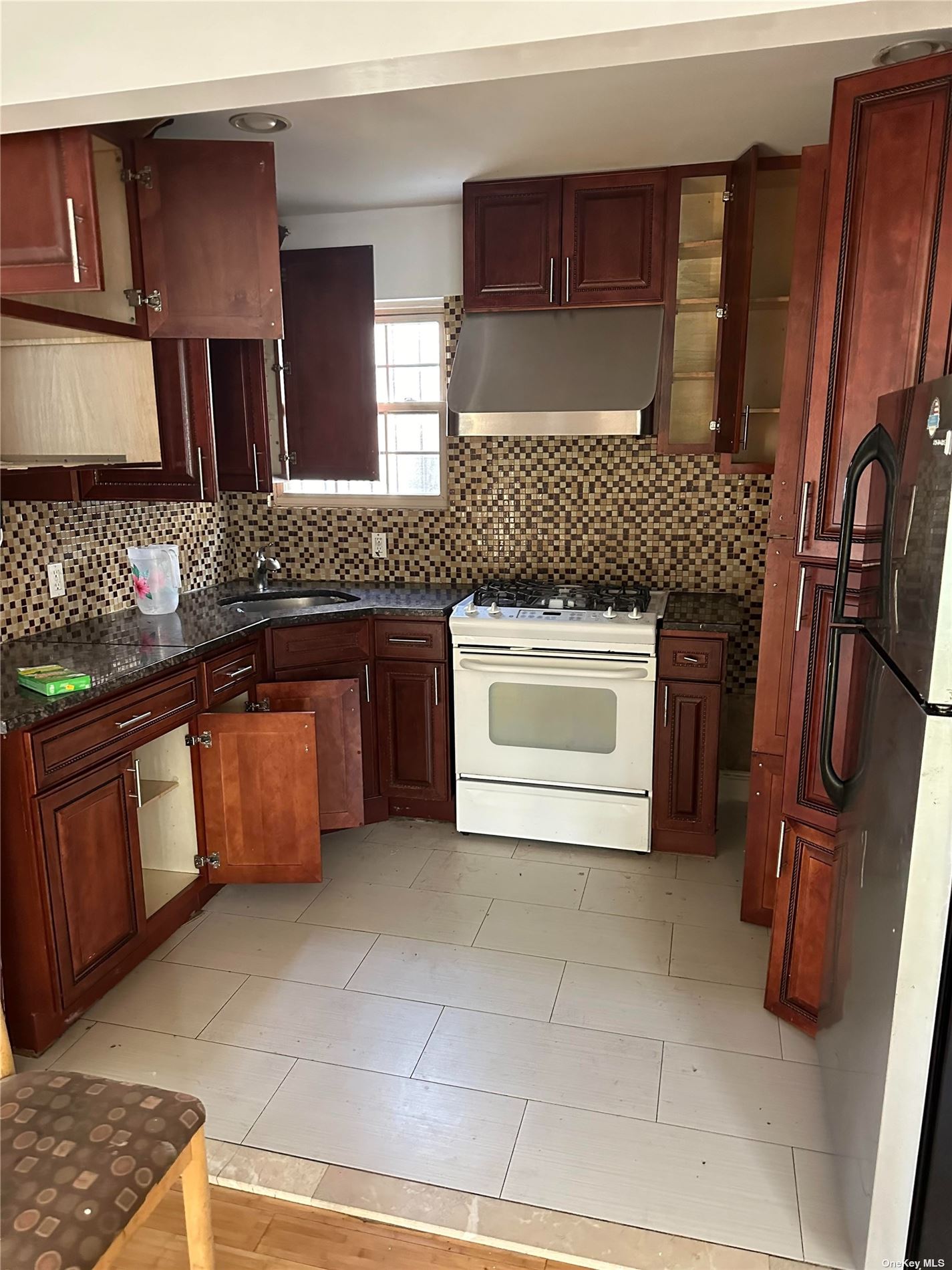 a kitchen with stainless steel appliances granite countertop a sink and a stove