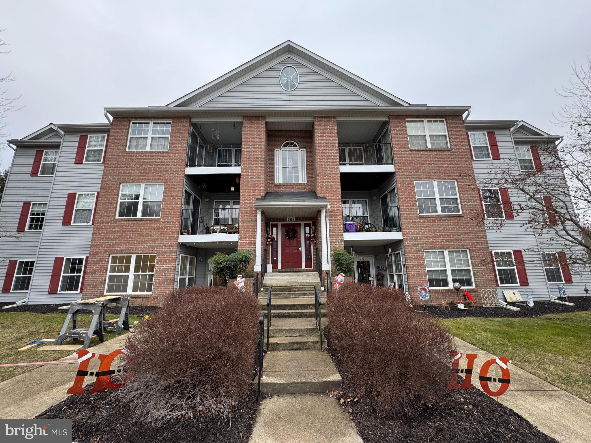 a front view of a residential apartment building with a yard