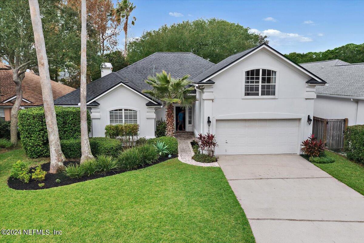 a view of house with yard and green space