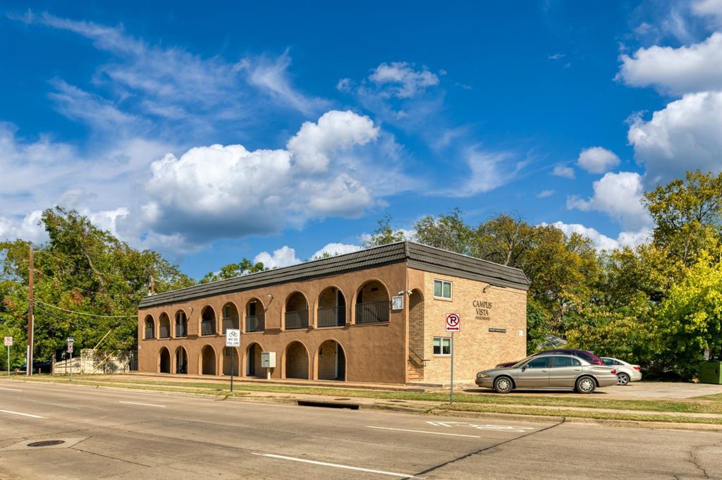 a view of a car parked in front of a building