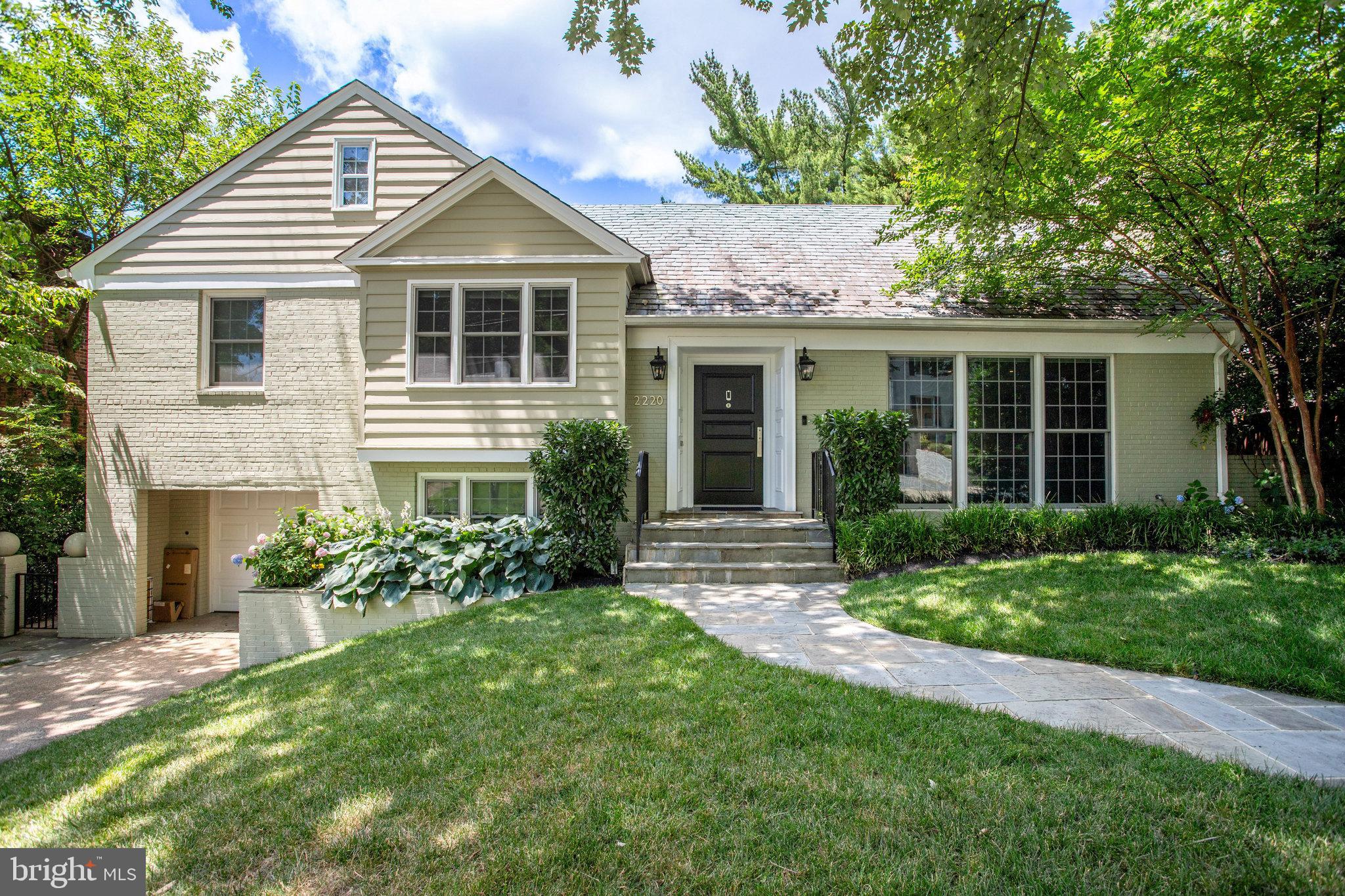 a view of a house with a yard and plants