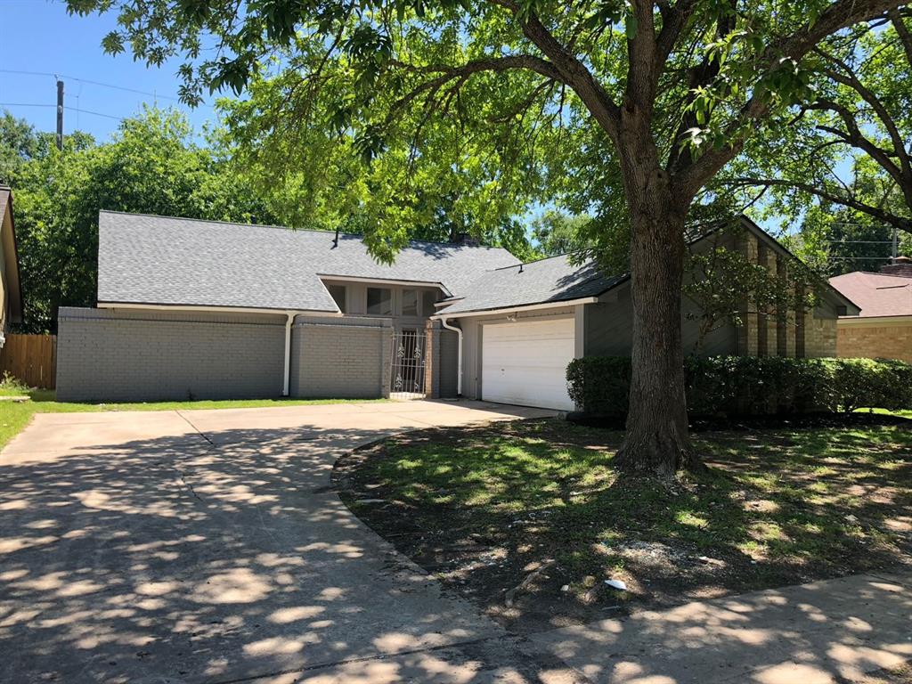 a house that has a tree in front of it