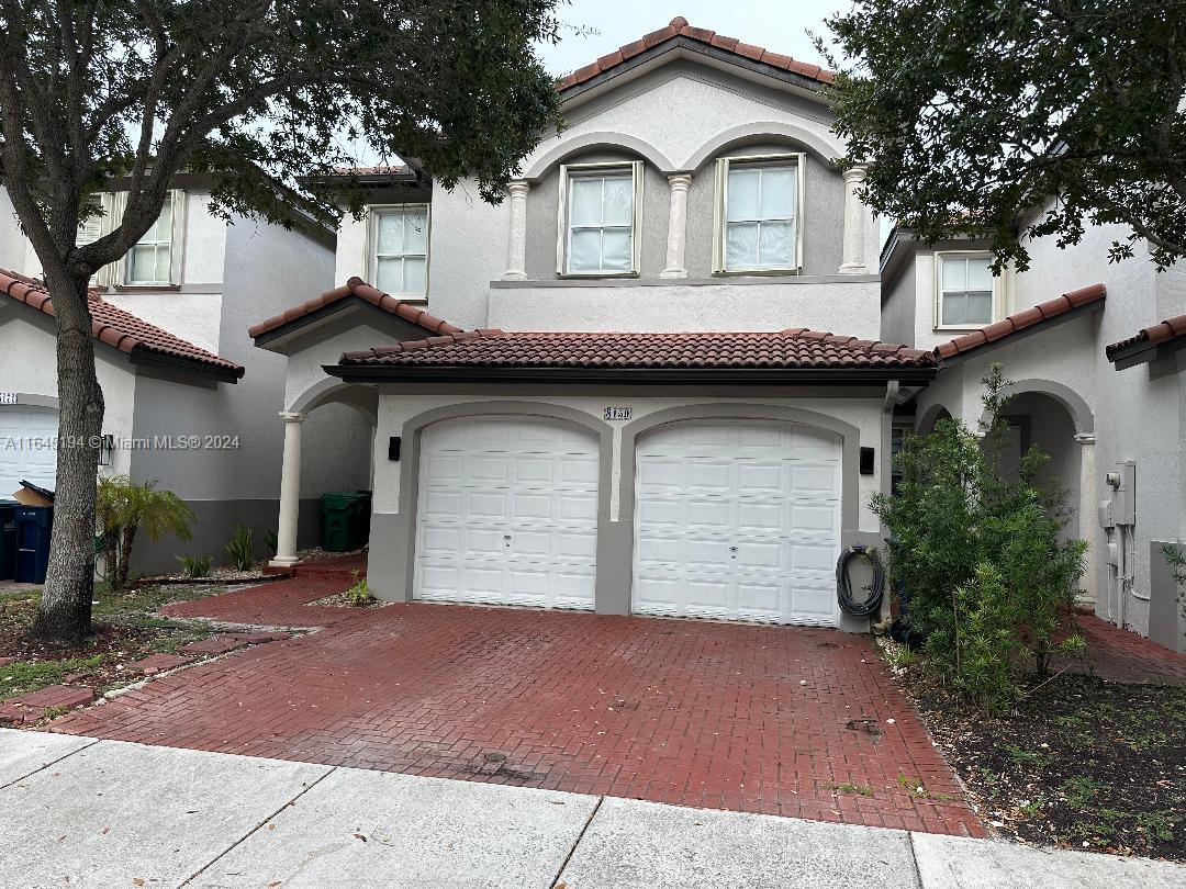 a front view of a house with a garage