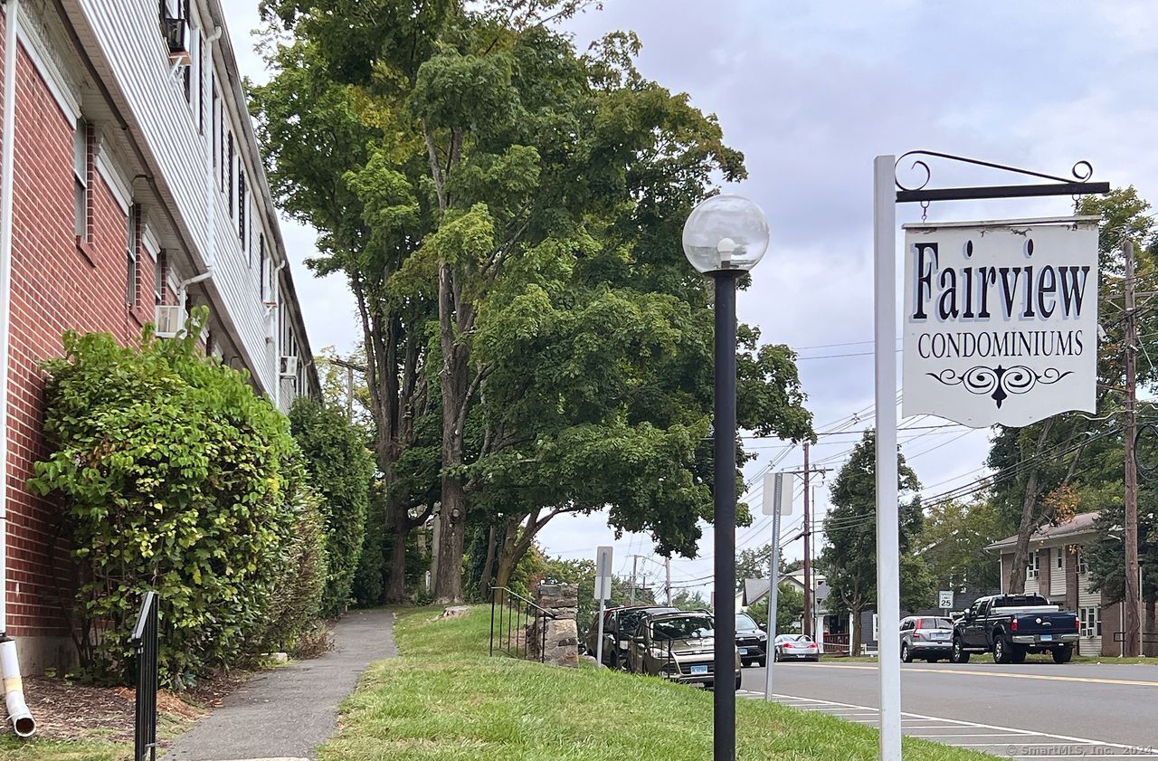 a street sign on a sidewalk next to a road