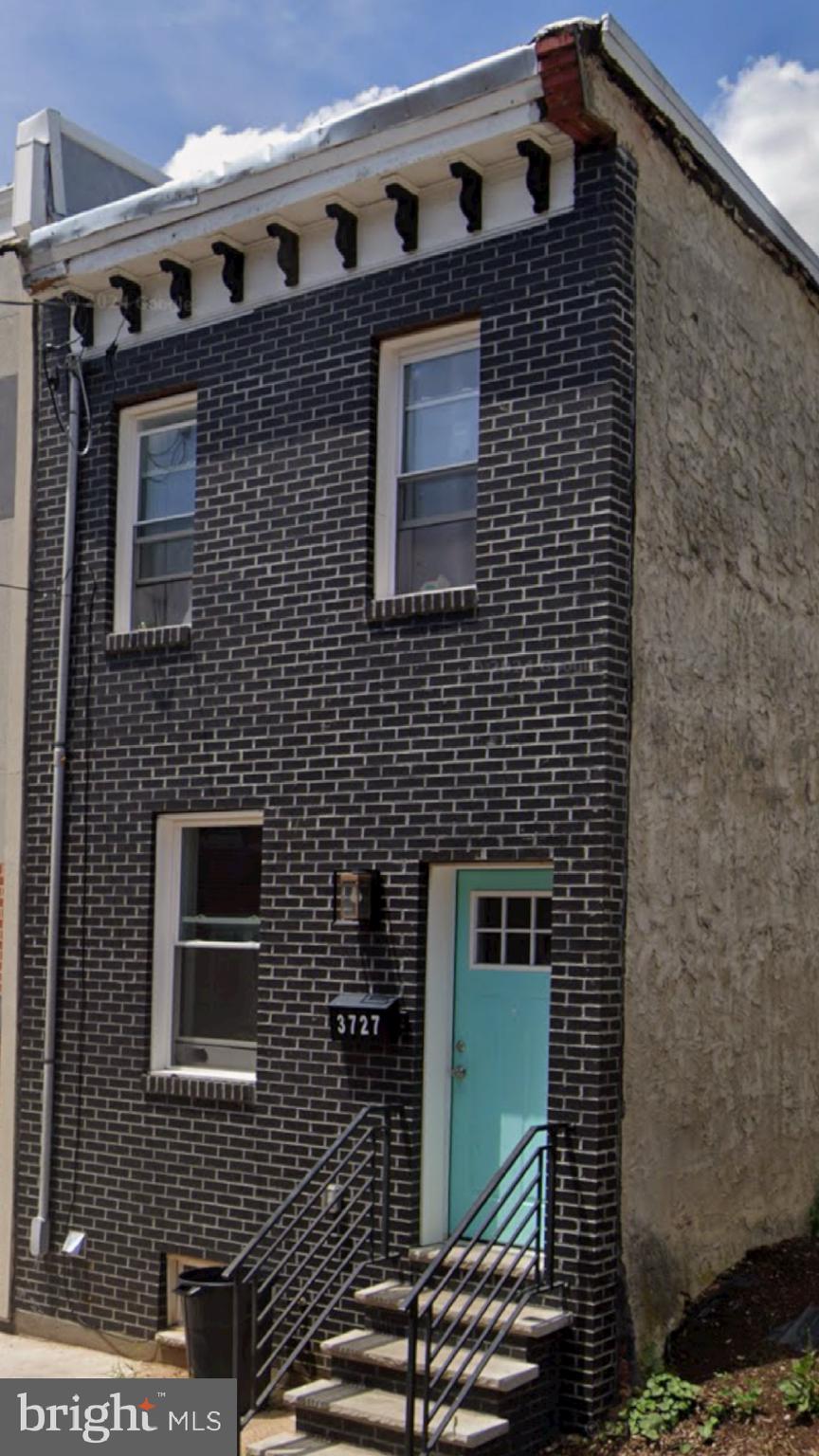 a brick building with a door and a door