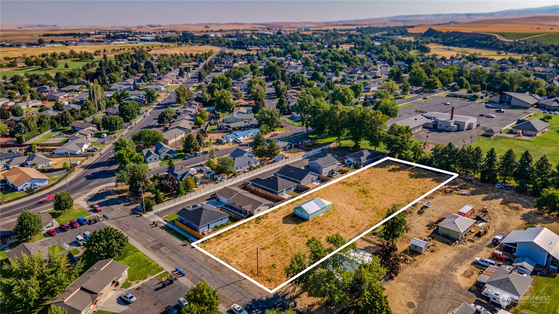 an aerial view of a tennis ground and a houses