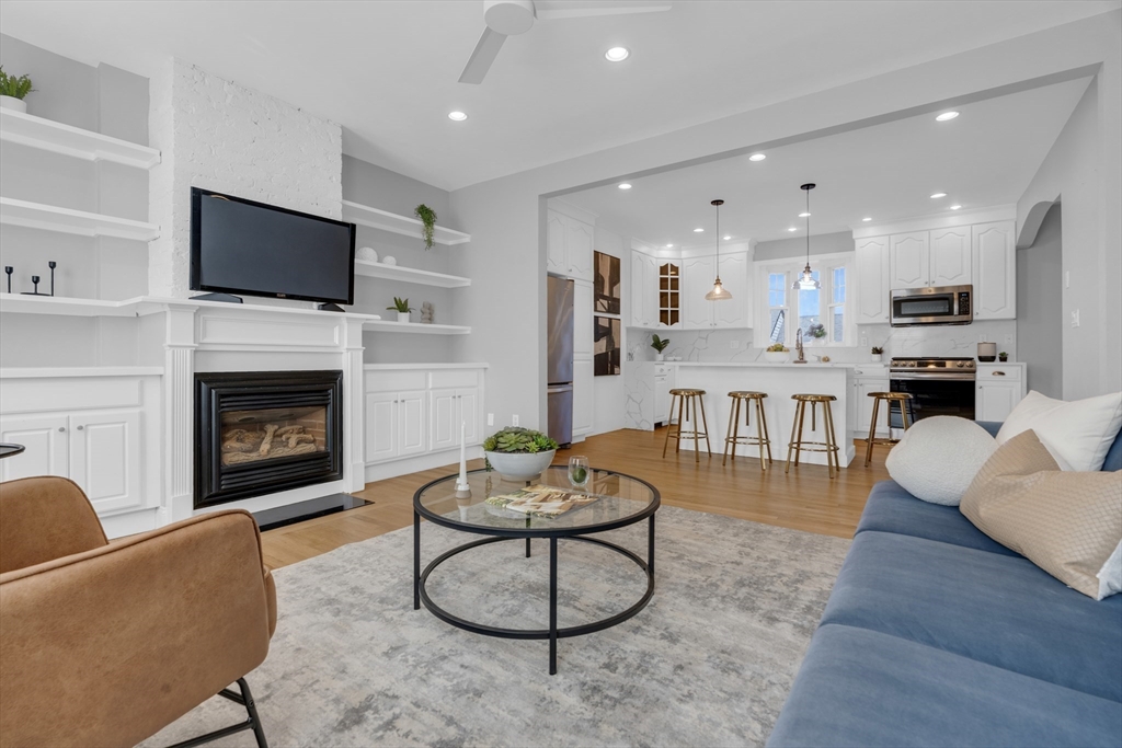 a living room with furniture a fireplace and a flat screen tv