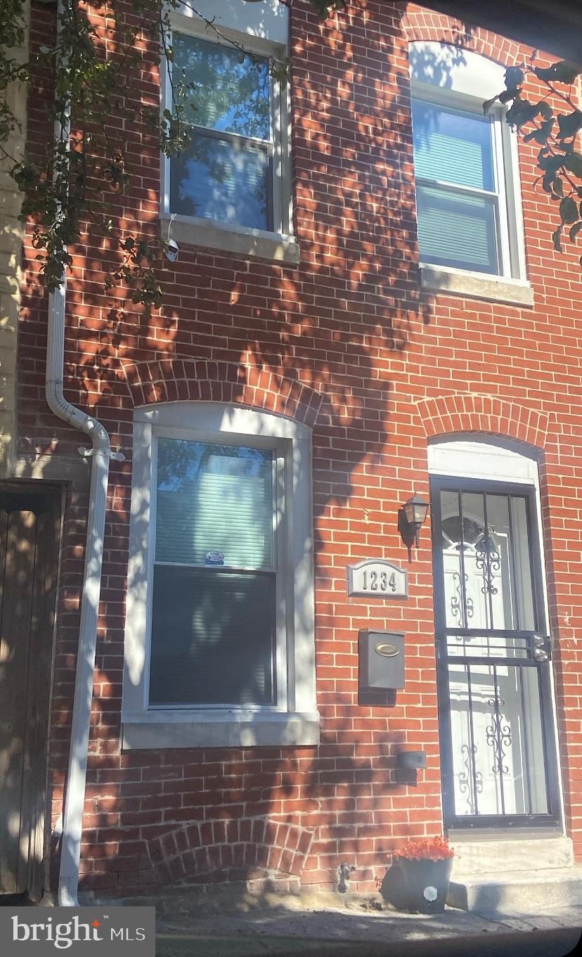 a view of a brick house with a street