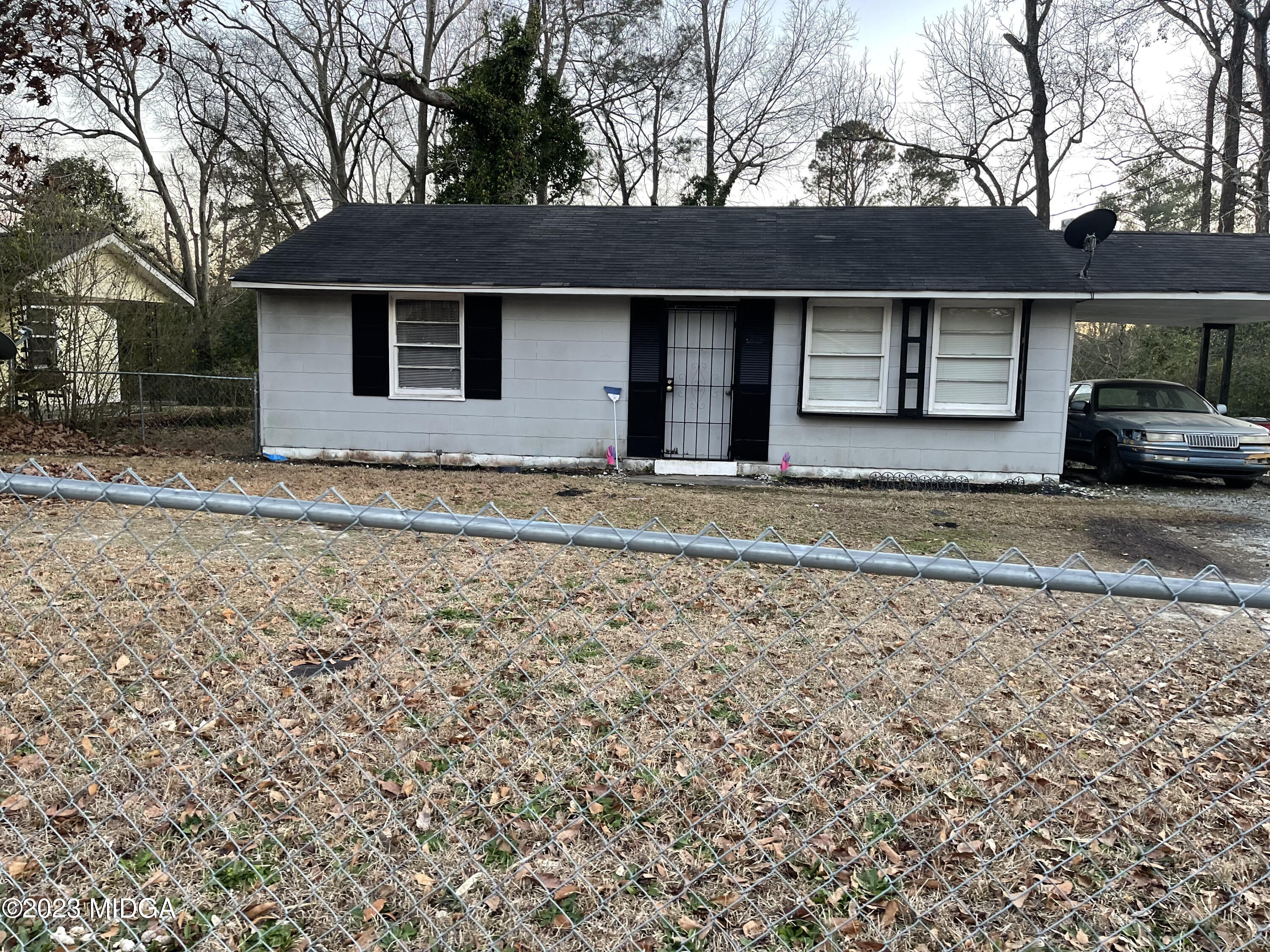 a view of a house with a yard and sitting area