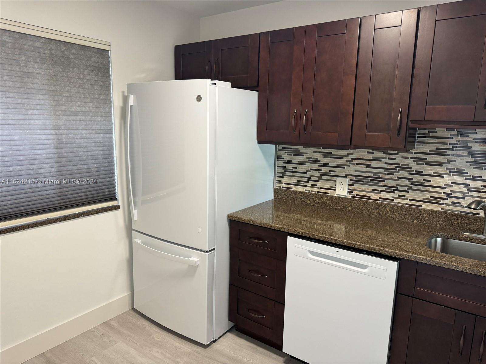 a white refrigerator freezer sitting inside of a kitchen