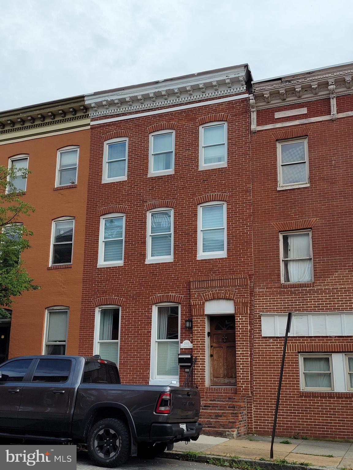 a front view of a building with parking space