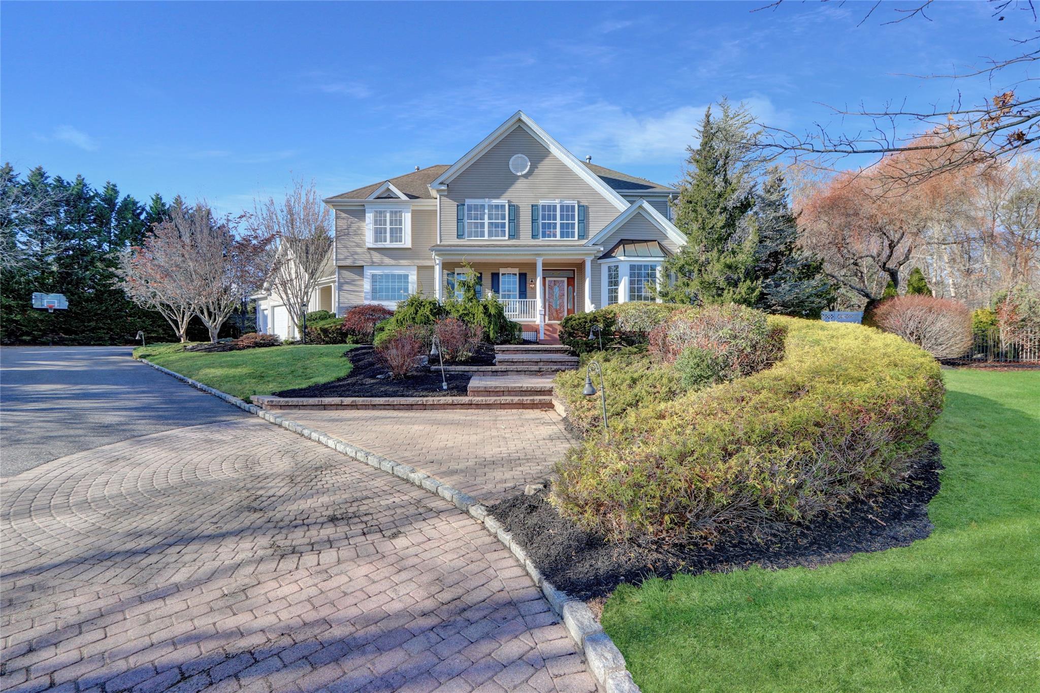 a front view of a house with a garden