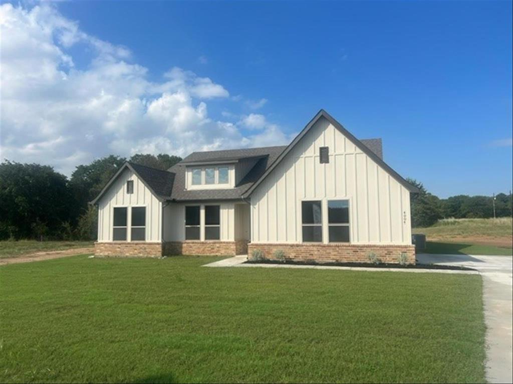 a front view of house with yard and green space