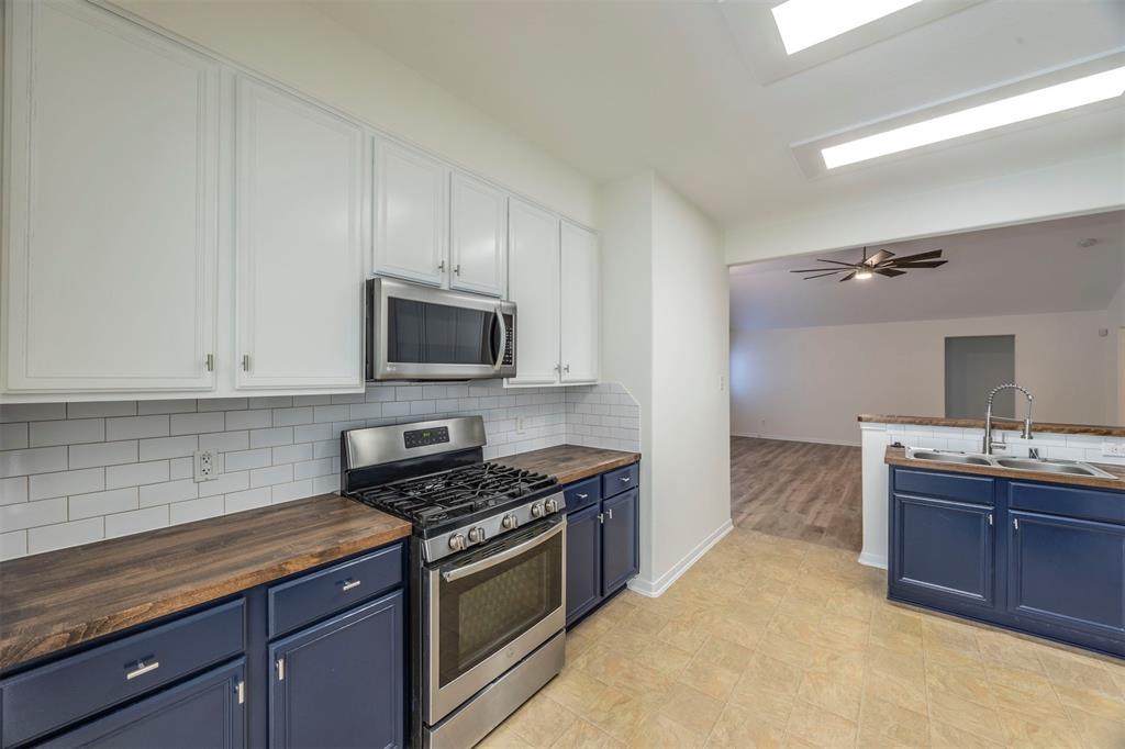 a kitchen with granite countertop a sink and a stove top oven