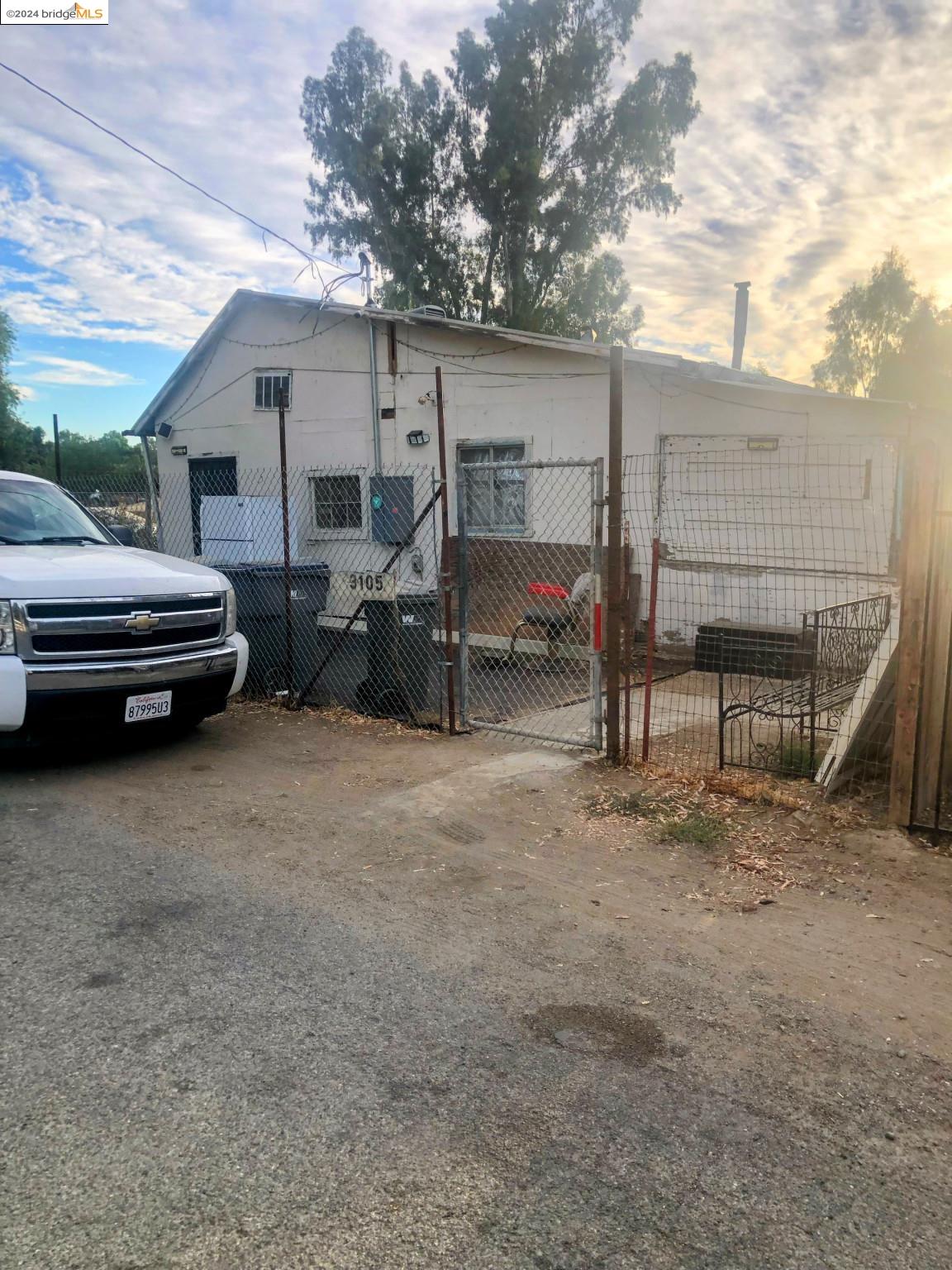 a view of a house with a backyard and chairs