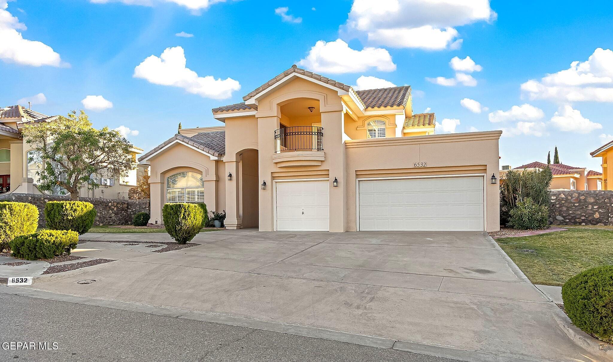 a view of a house with a outdoor space and a car parked in front of it