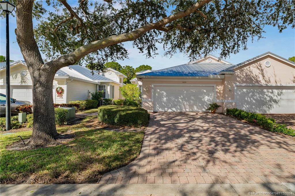 a view of a house with a yard and tree s