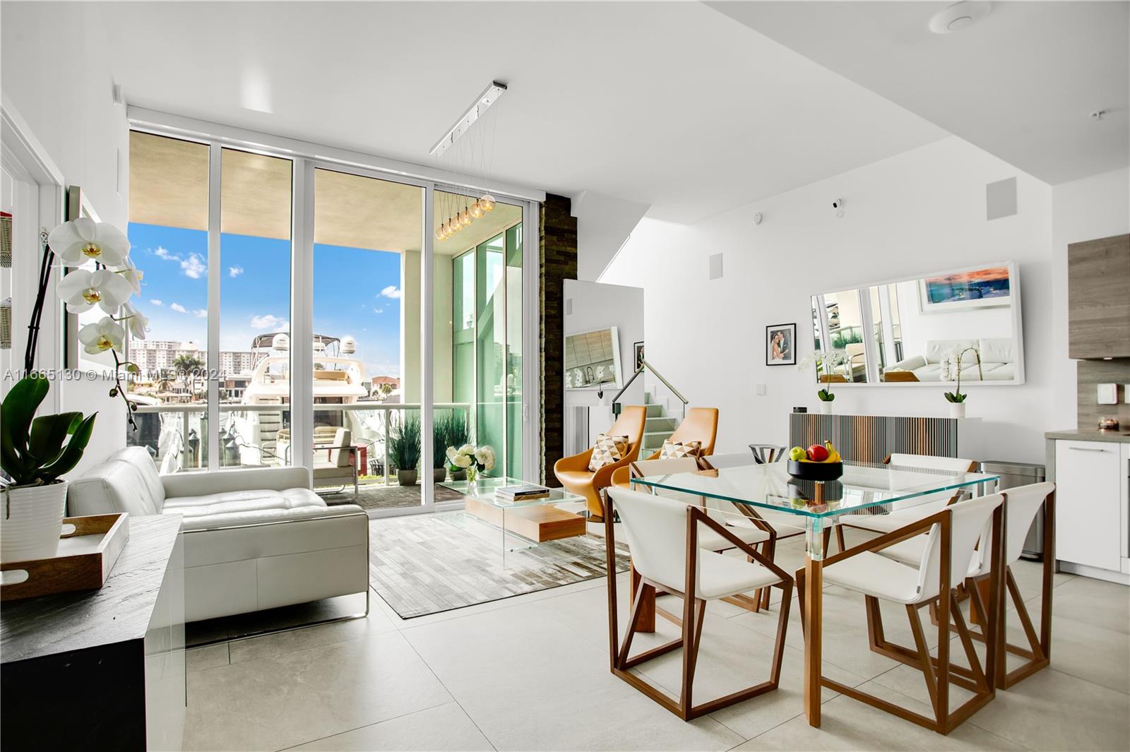 a dining room with furniture and a floor to ceiling window