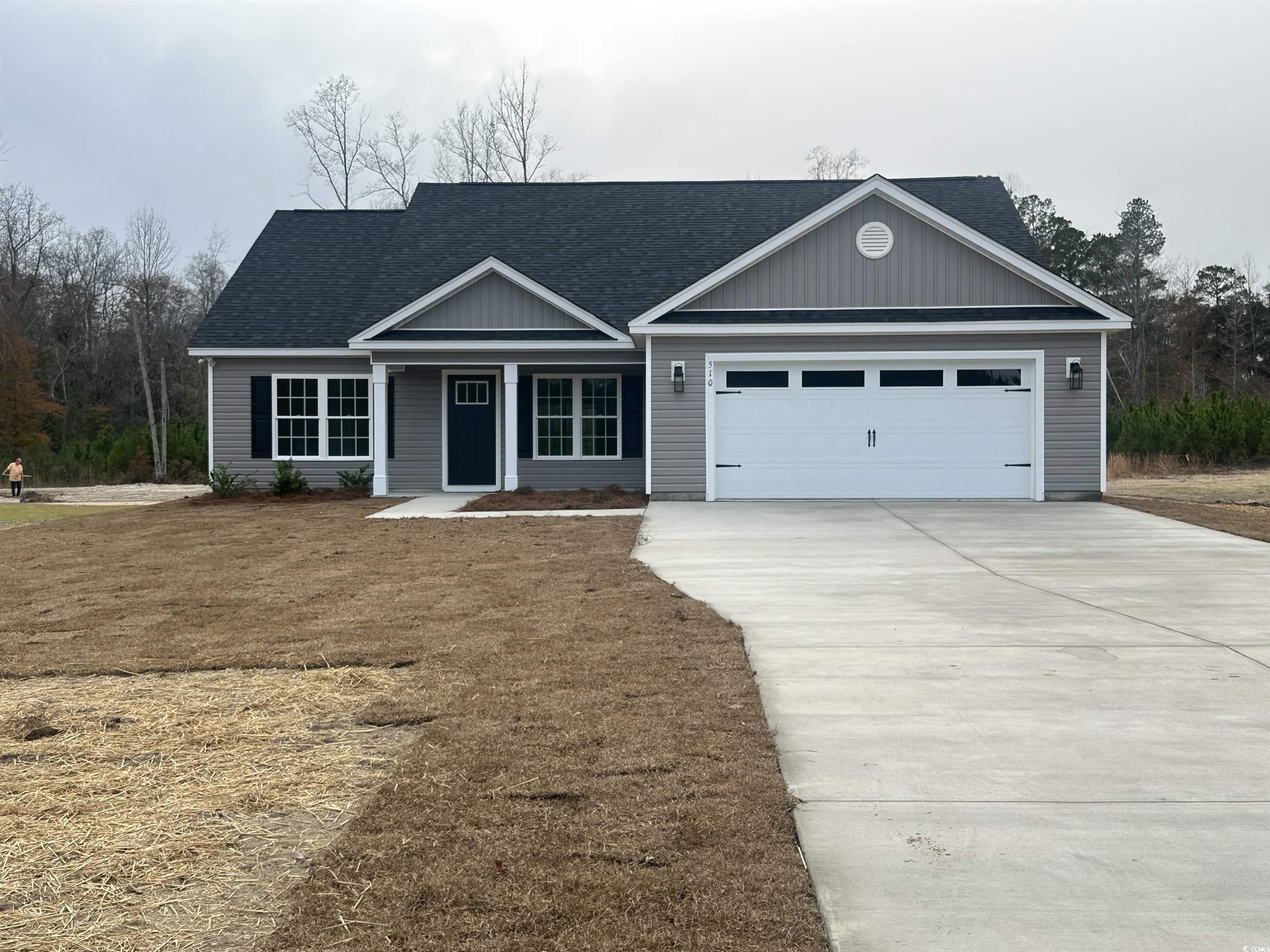 View of front of property featuring a garage