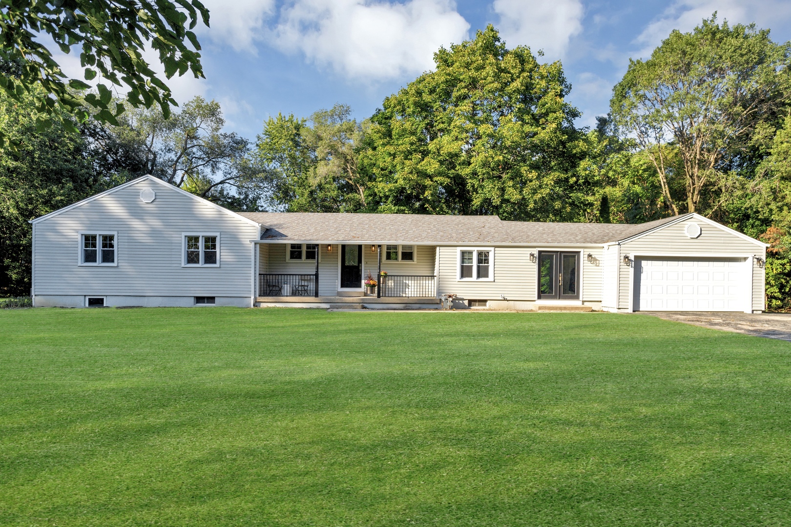 a front view of a house with a garden