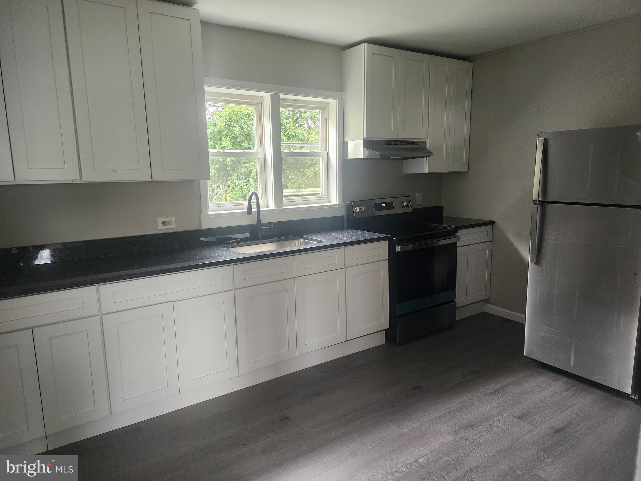 a kitchen with a sink stove and refrigerator