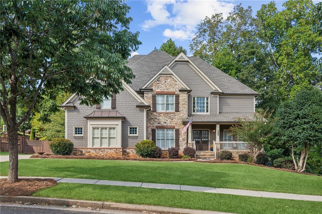 a front view of a house with a garden