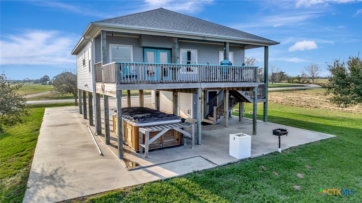 a view of a house with backyard porch and sitting area