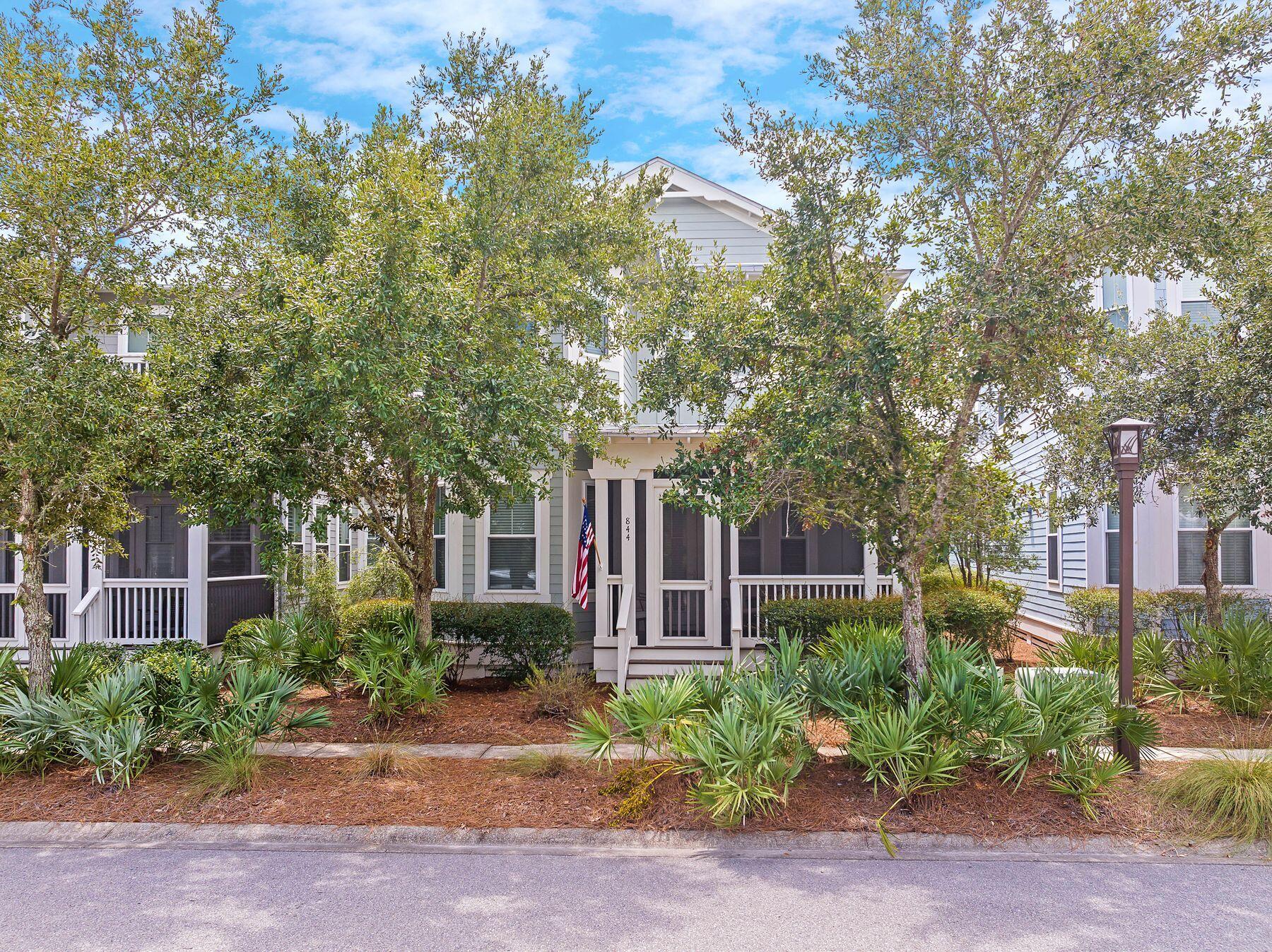 front view of a house with a tree