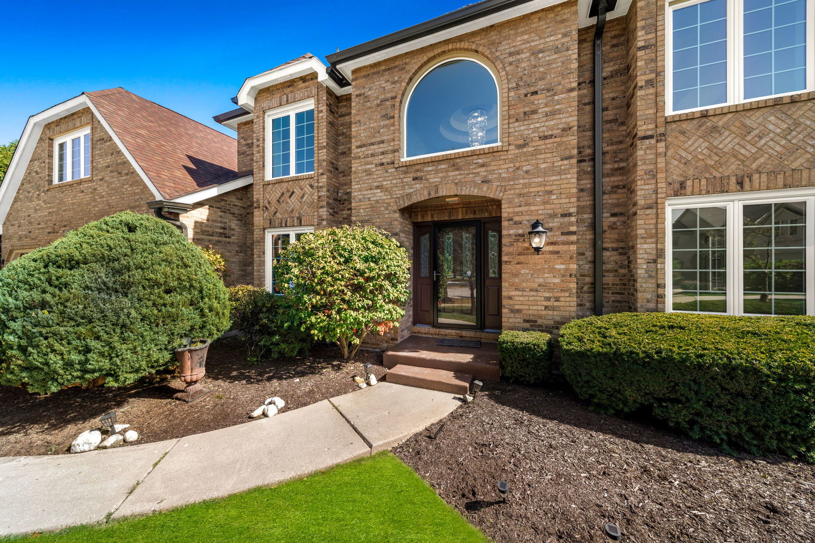 a front view of a house with garden