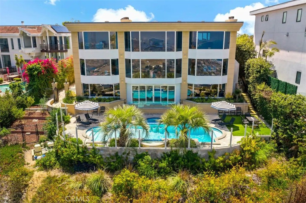 a view of a house with swimming pool and sitting area