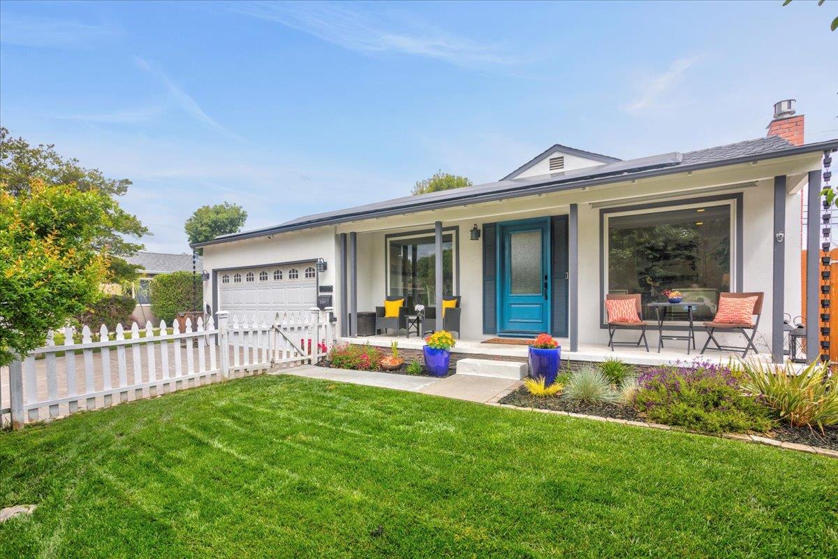 a view of a house with a yard and sitting area