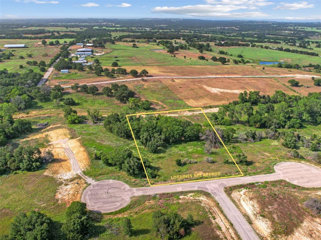 an aerial view of a houses with a yard