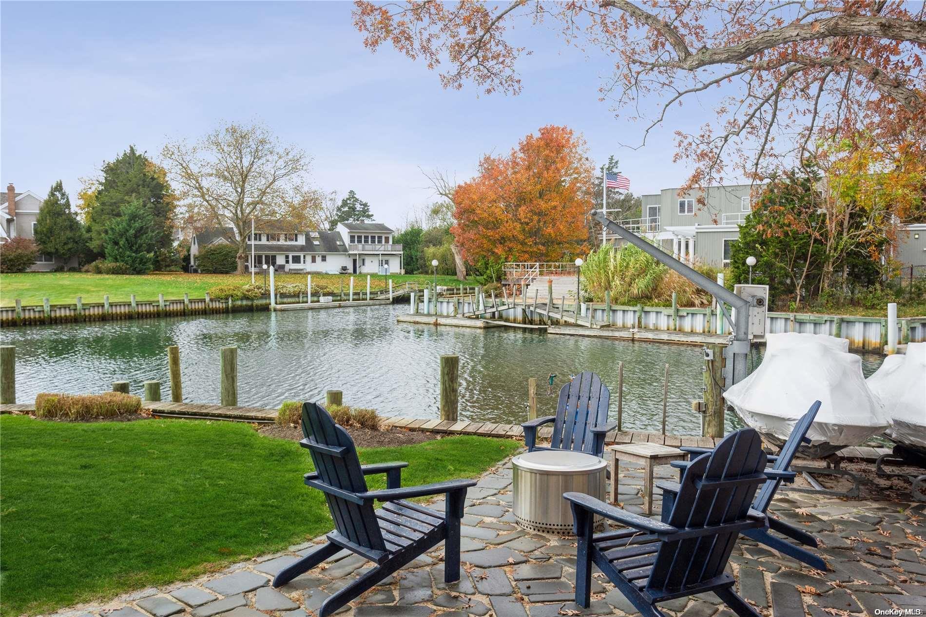 a view of a lake with table and chairs