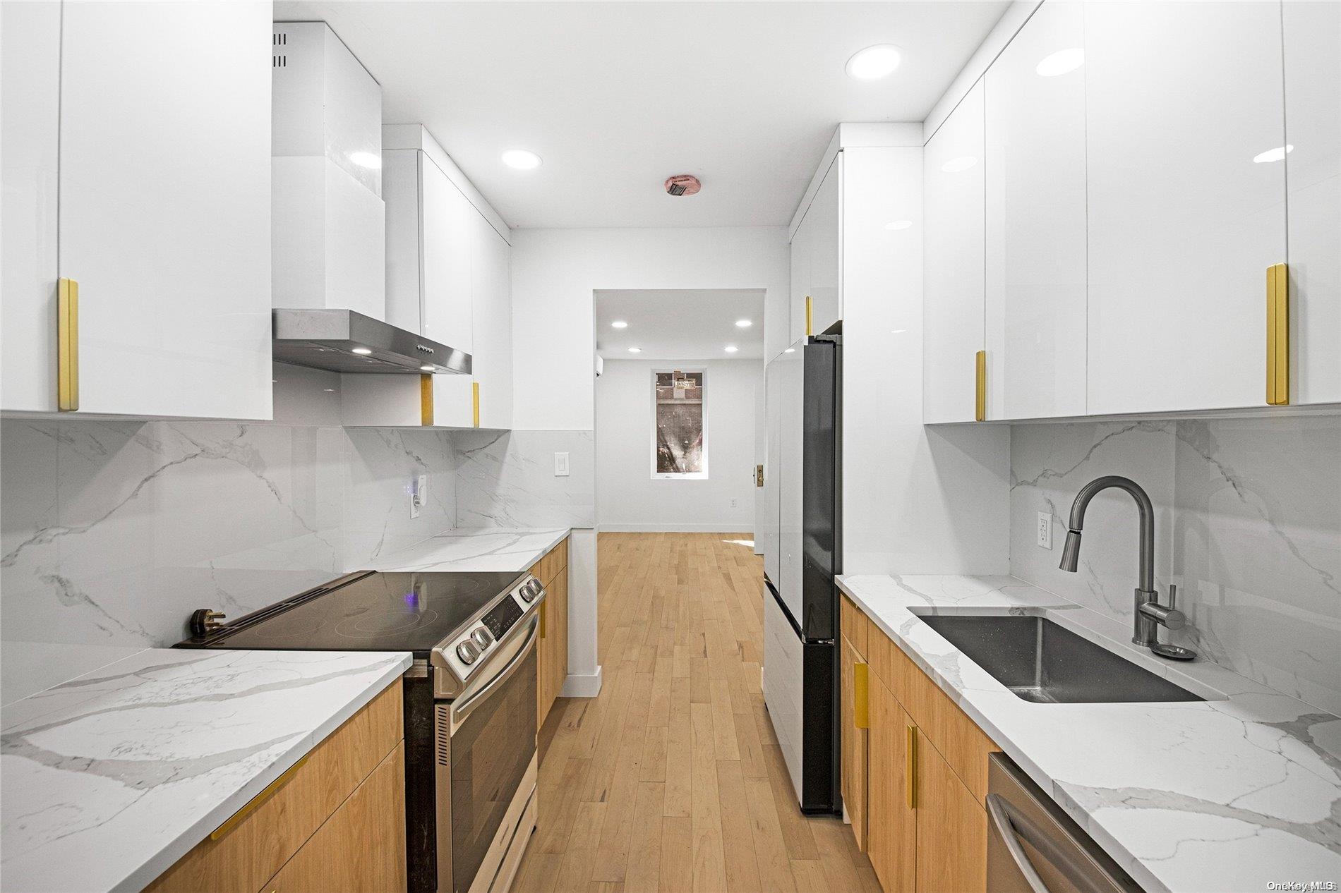 a kitchen with a sink a stove and cabinets