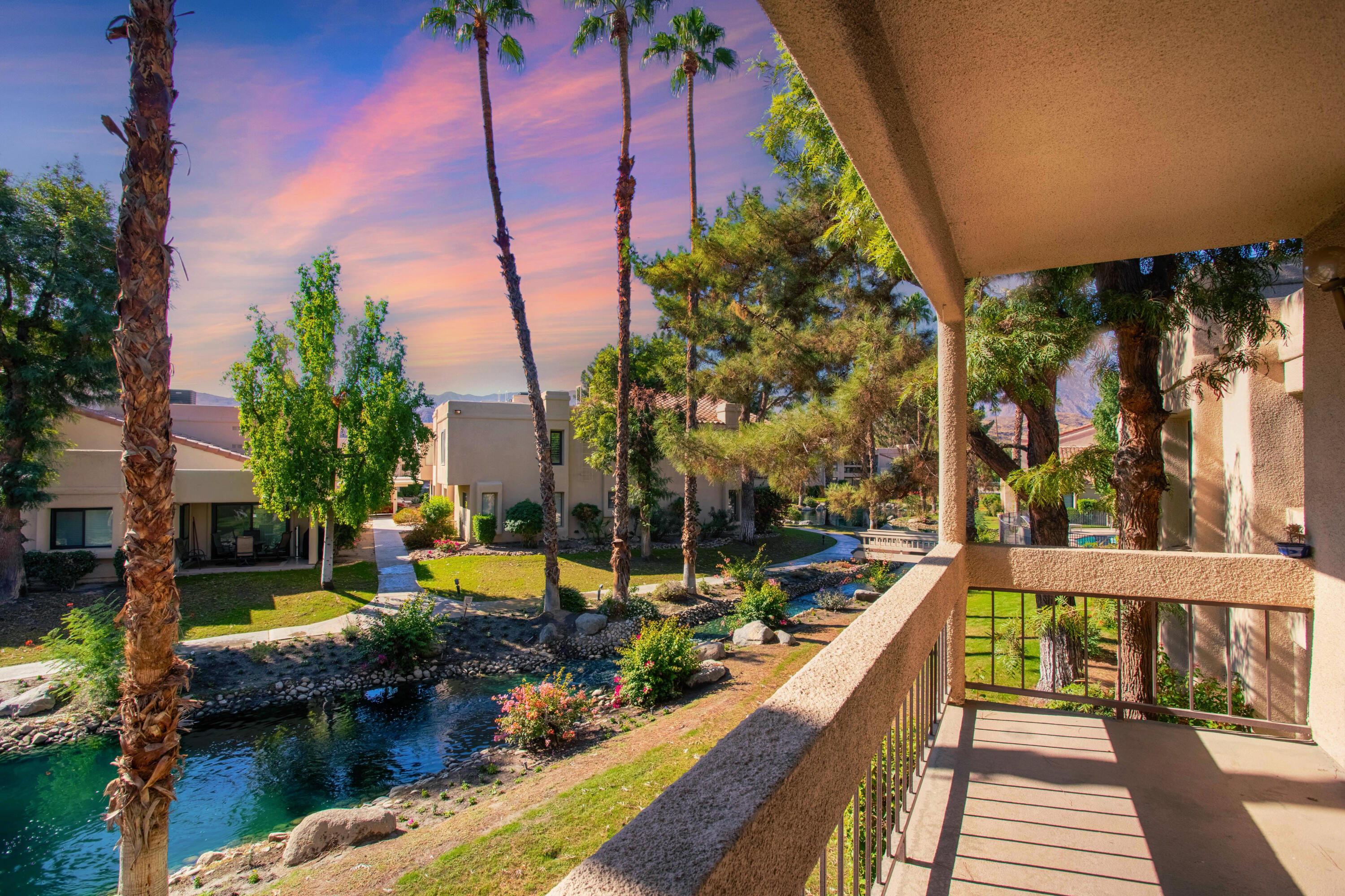 a view of a house with swimming pool and sitting area