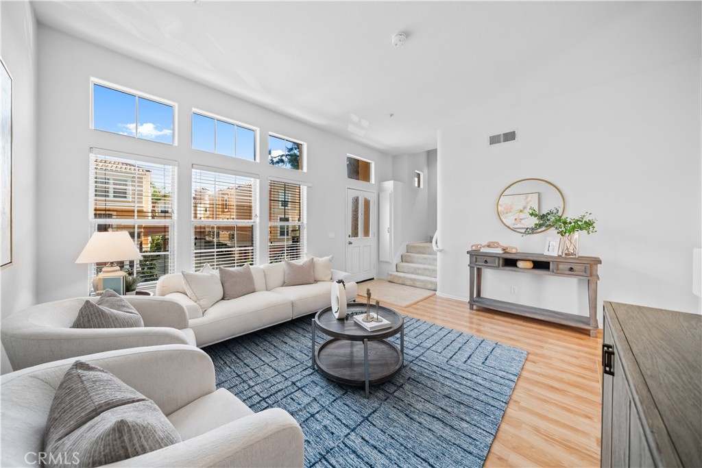 a living room with furniture and wooden floor